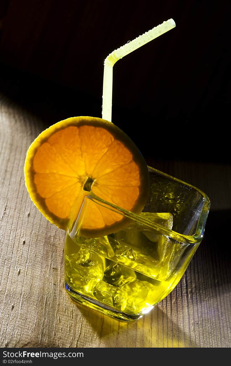 Glass with cocktail on wood background