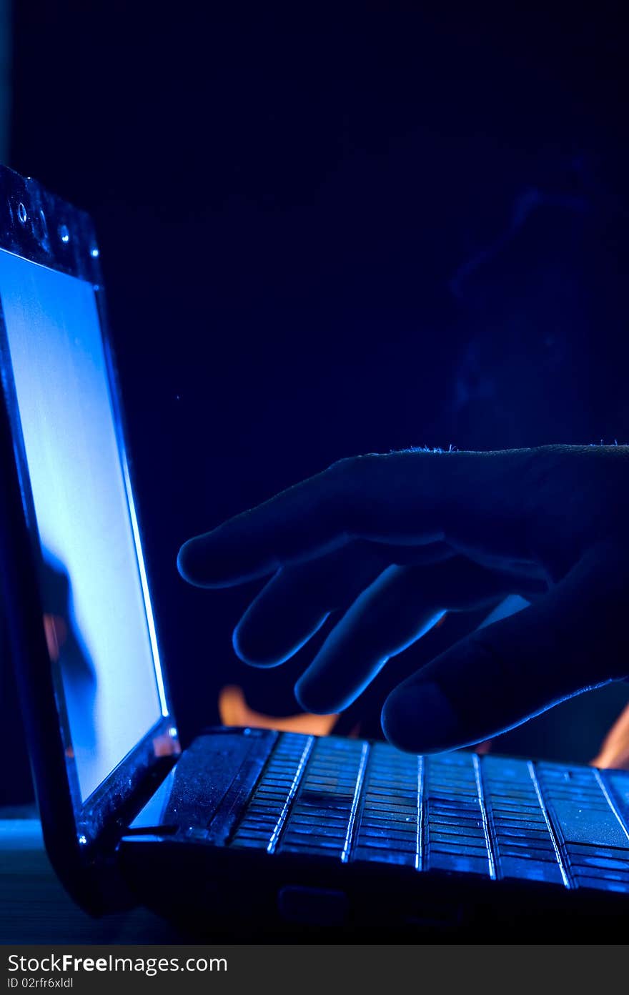 Laptop and human hand on blue background. Laptop and human hand on blue background