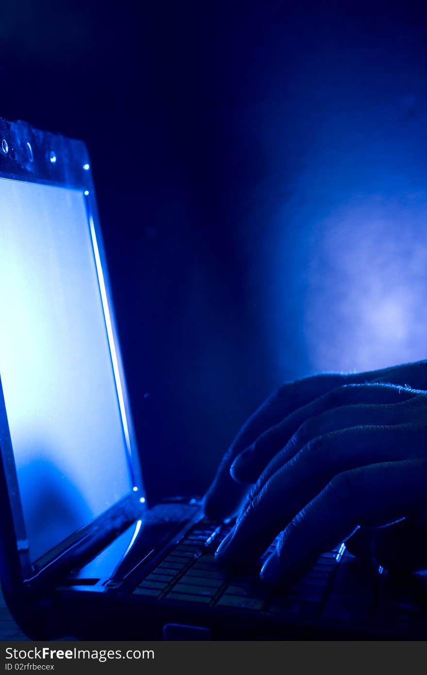 Laptop and human hand on blue background. Laptop and human hand on blue background