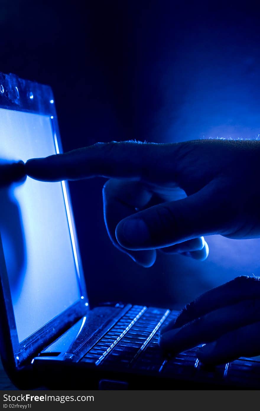 Laptop and human hand on blue background. Laptop and human hand on blue background