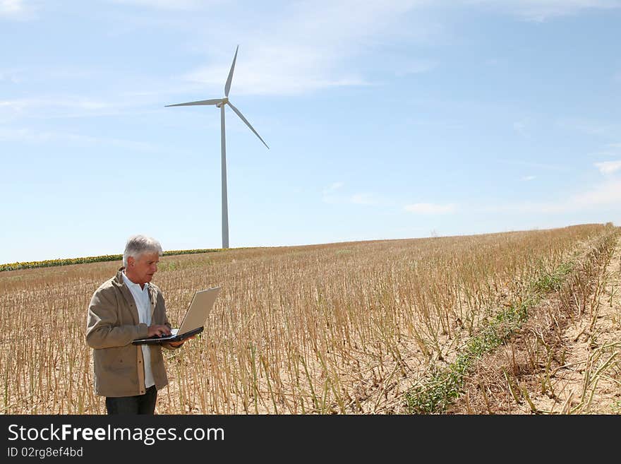 Agronomist in wheat field with laptop computer. Agronomist in wheat field with laptop computer