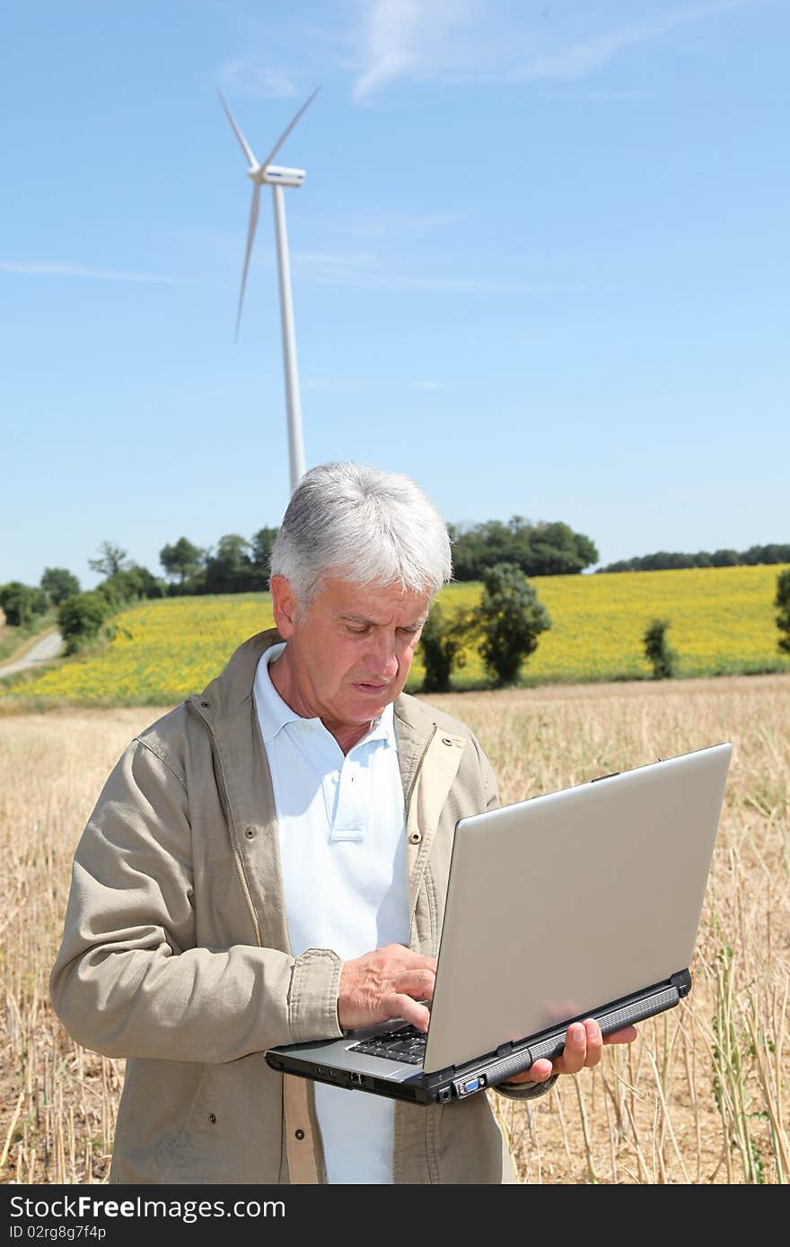 Agronomist in wheat field with laptop computer. Agronomist in wheat field with laptop computer