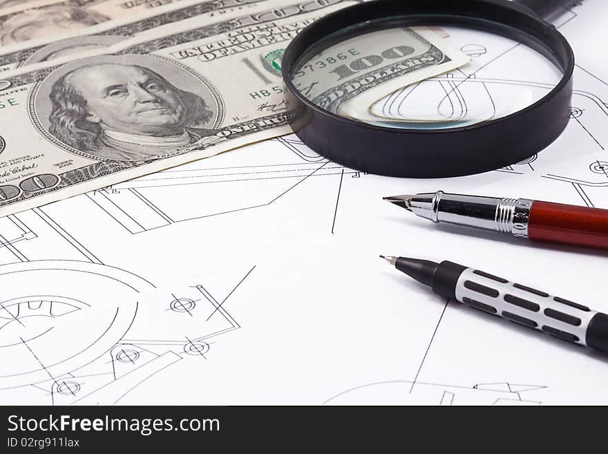 Magnifying glass and dollars on drafting. Magnifying glass and dollars on drafting