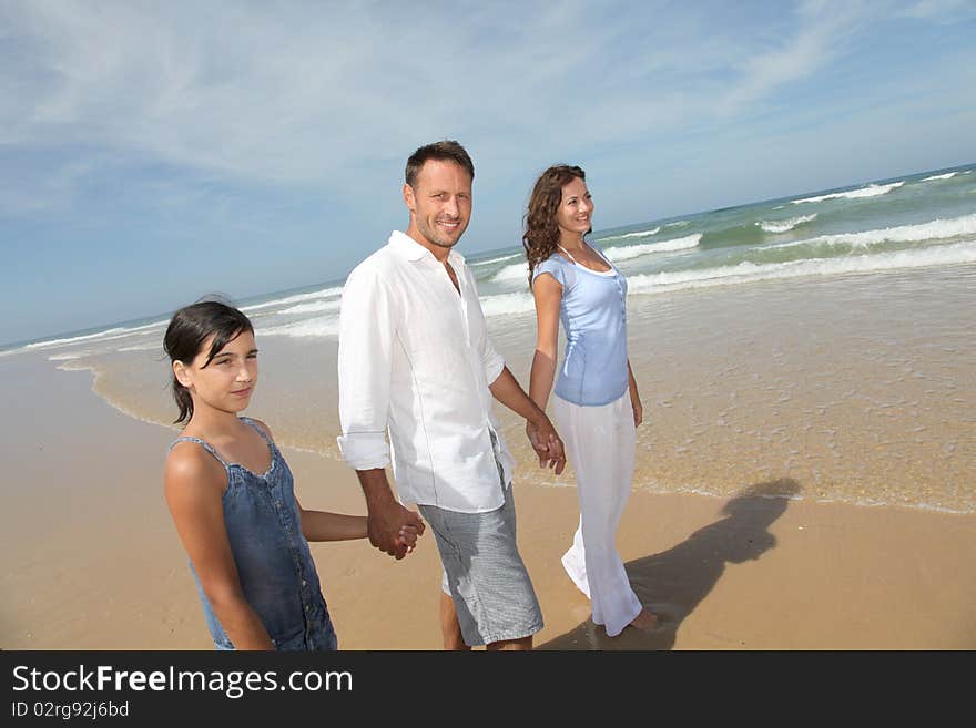 Family walking by the beach in summer. Family walking by the beach in summer