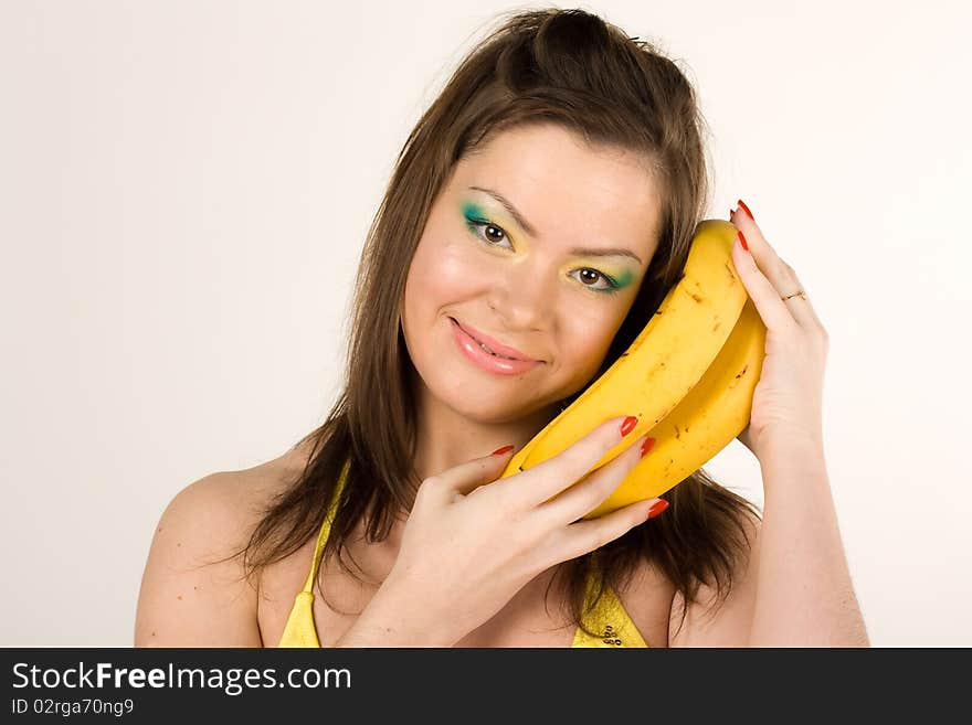 Young attractive girl with a banana isolated on a white background. Young attractive girl with a banana isolated on a white background