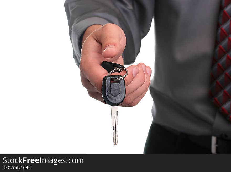 The businessman in a grey shirt and a tie stretches a car key. The businessman in a grey shirt and a tie stretches a car key.