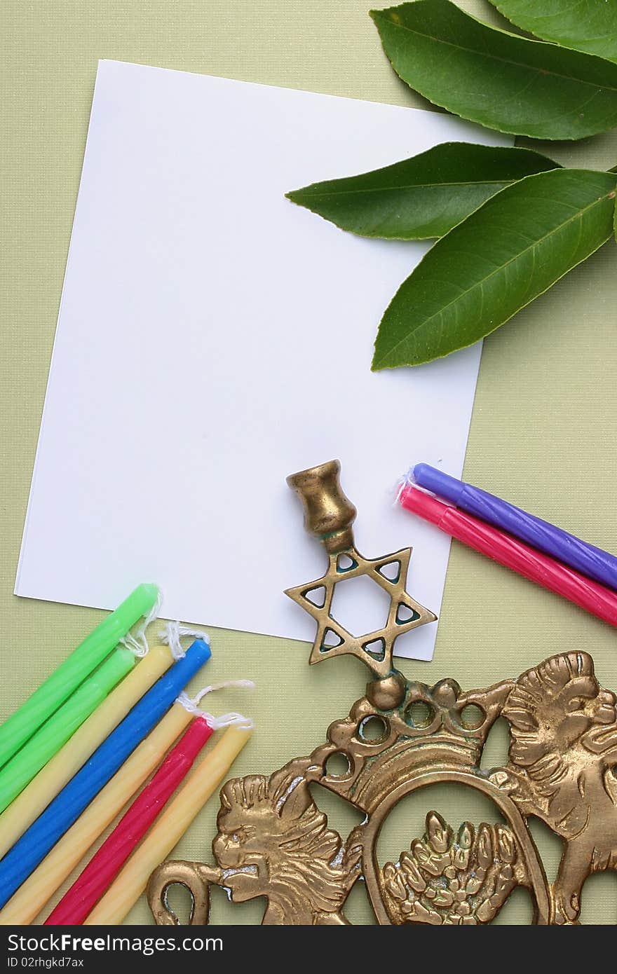 Menorah and candles next to a piece of white paper. Add your text to the paper.