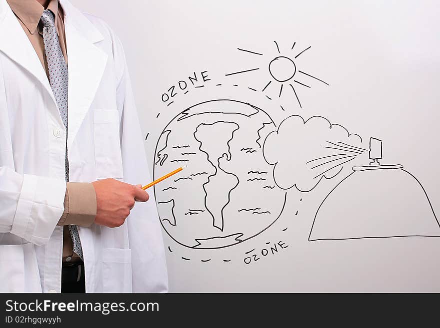 Man in a white lab coat pointing to a drawing of the earth being in danger. Man in a white lab coat pointing to a drawing of the earth being in danger.