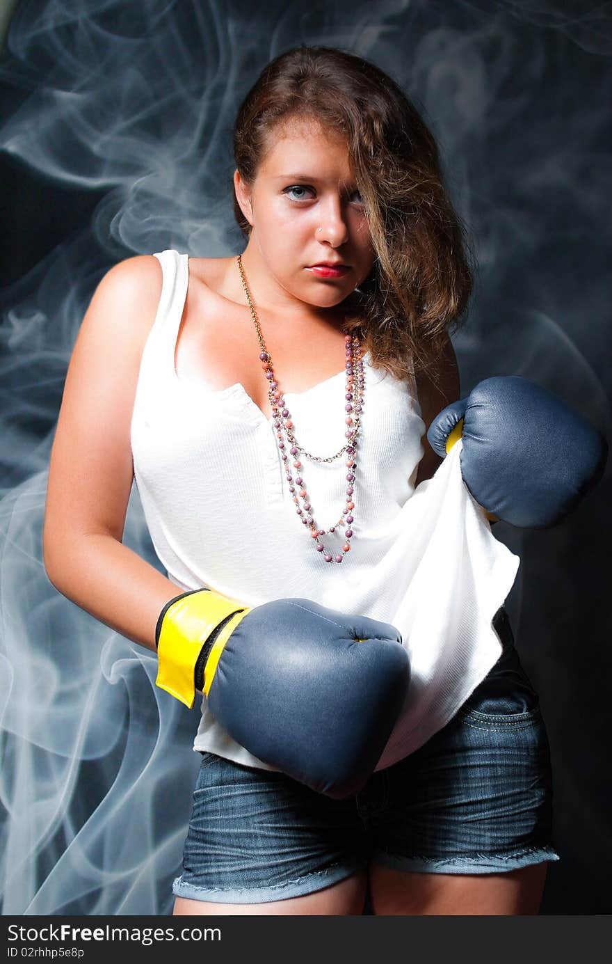 Young beautiful woman in boxing gloves. Young beautiful woman in boxing gloves