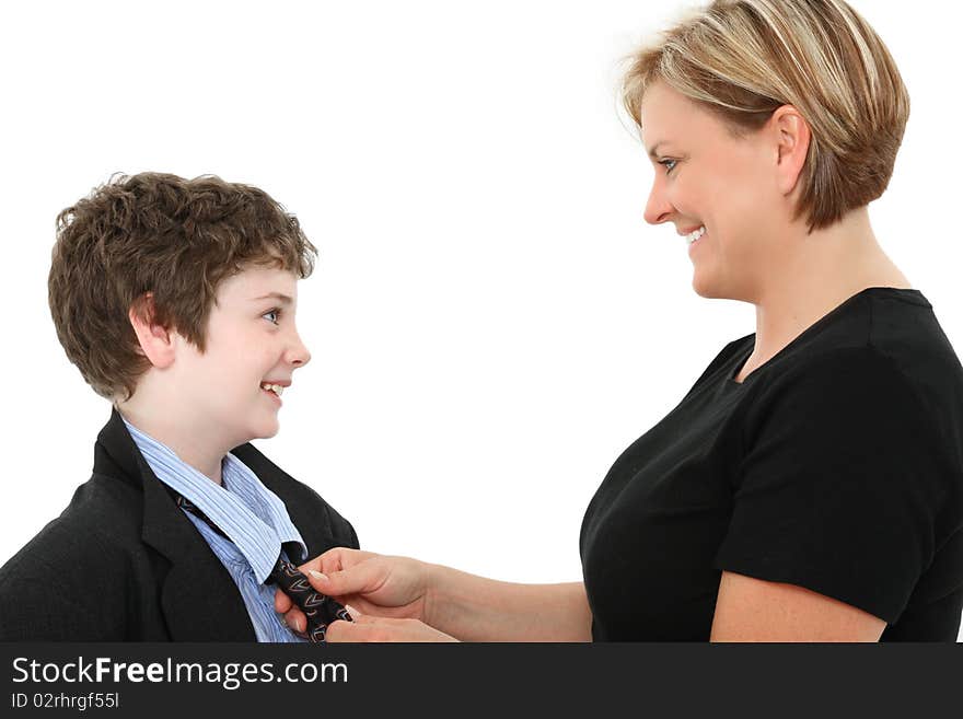 Mom helping adorable american 10 year old boy fix his tie in baggy over sized suit over white. Mom helping adorable american 10 year old boy fix his tie in baggy over sized suit over white.