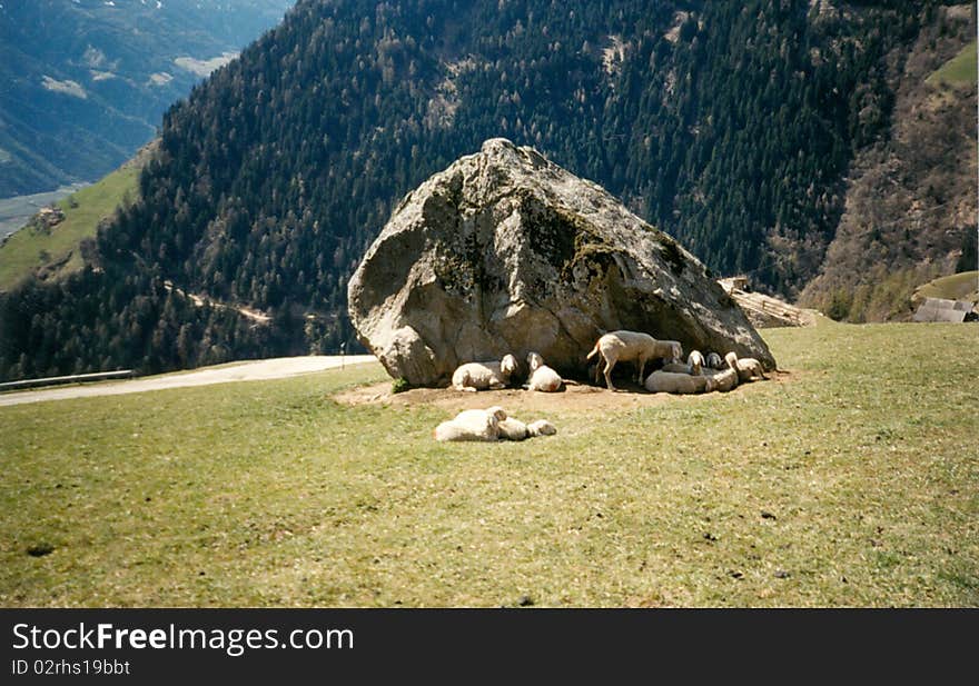 Big rock on meadow in the mountains