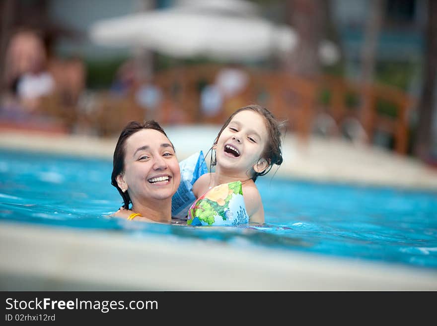 Mother and daughter in the swimming pool