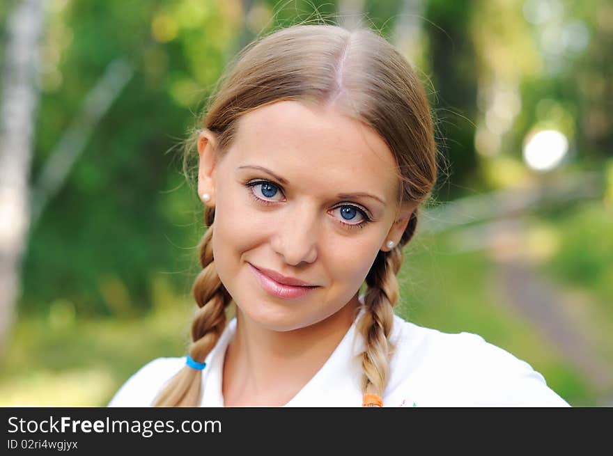 Young beautiful girl in a summer forest