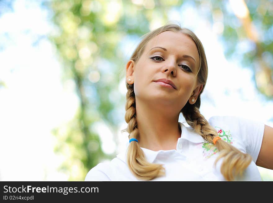 Young beautiful girl in a summer forest