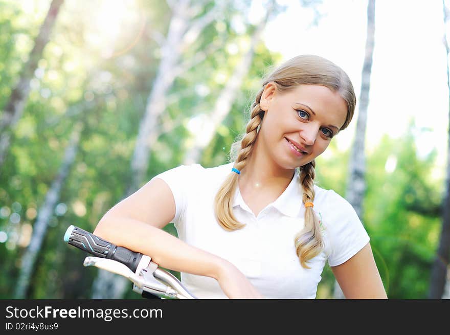 Young beautiful girl in a summer forest