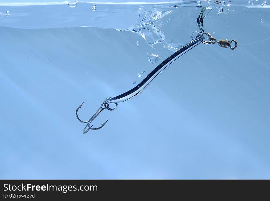 Metal fishing lure near surface of water