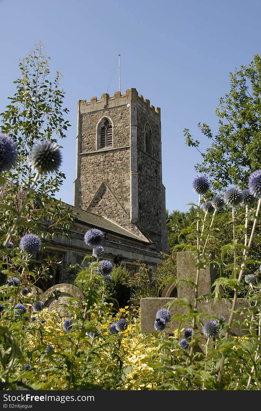 Historic British village church,with  garden flowers and stones. Historic British village church,with  garden flowers and stones.