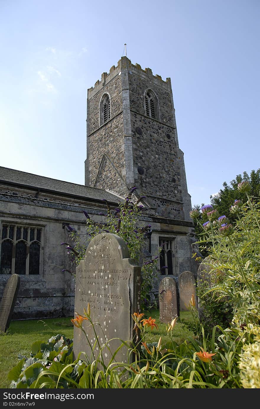 Old church in English village,with gravestones and flowers. Old church in English village,with gravestones and flowers.