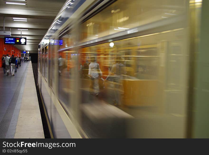 Moving train in a underground train station. Moving train in a underground train station