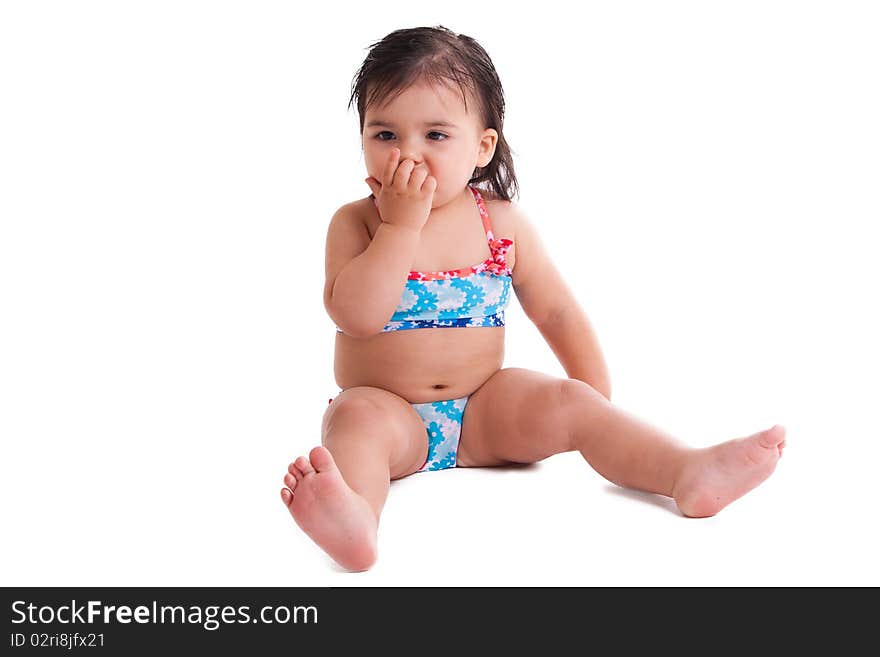 Little girl in swimming suit eating candy