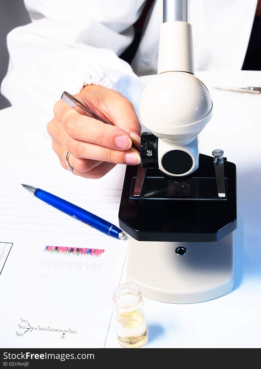 Microscope and female doctor's hand. Microscope and female doctor's hand