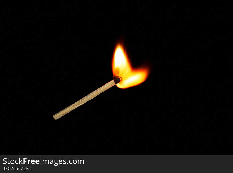 Light a match on a black background. Light a match on a black background