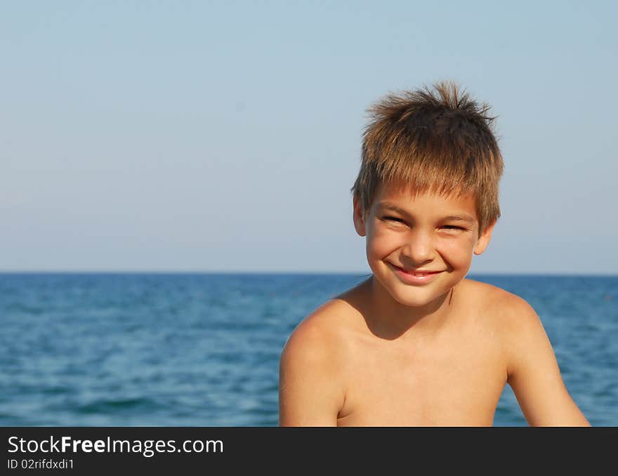 Happy teen boy smiling portrait on seaside. Happy teen boy smiling portrait on seaside