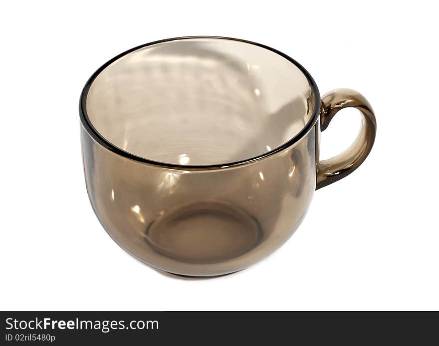 Transparent teacup made of glass isolated on the white background