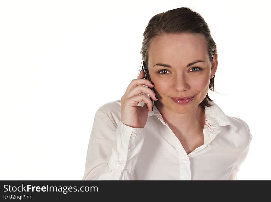 Beautiful girl speaking on the phone, seen against white background