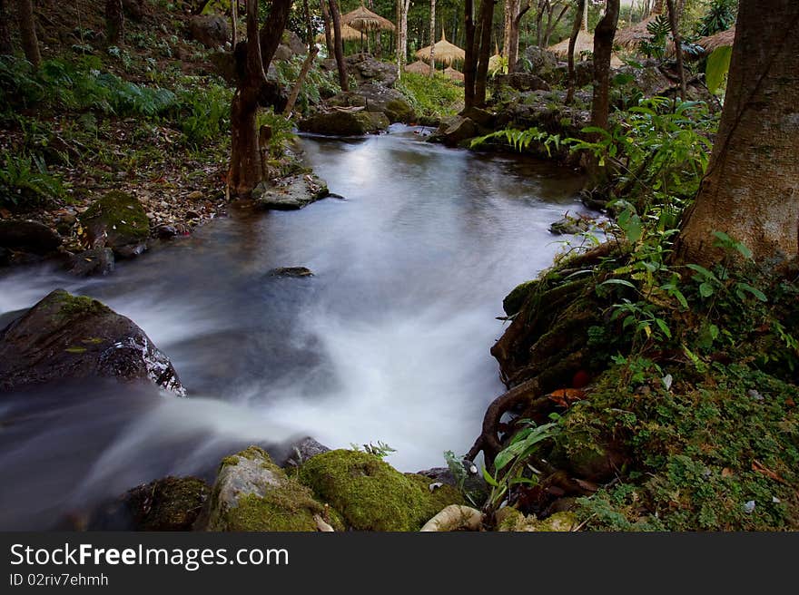 A small waterfall in a park. A small waterfall in a park.