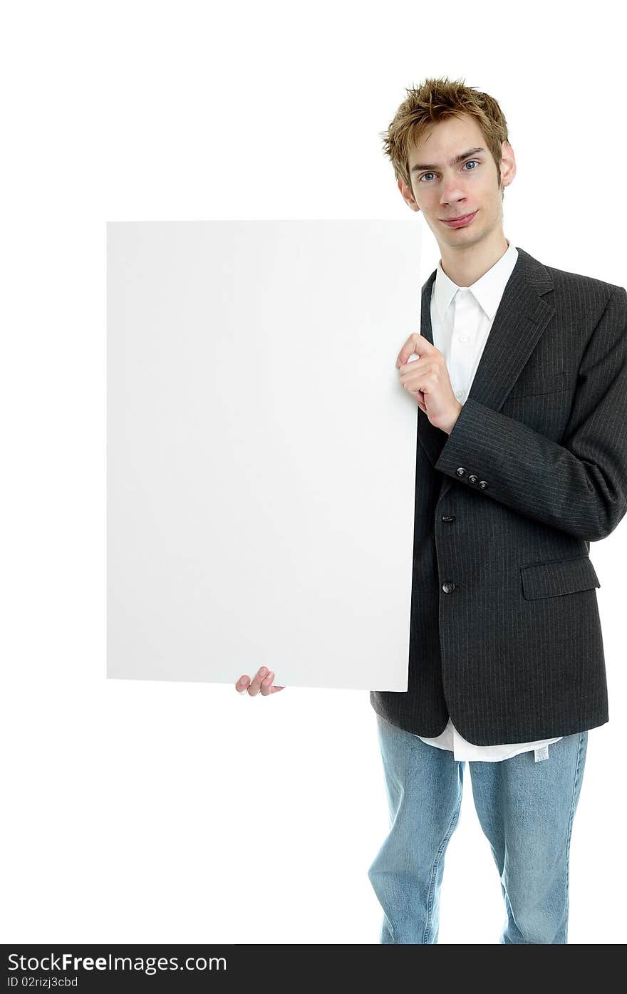 Young businessman holding a white cardboard sign with copyspace while standing up. Young businessman holding a white cardboard sign with copyspace while standing up