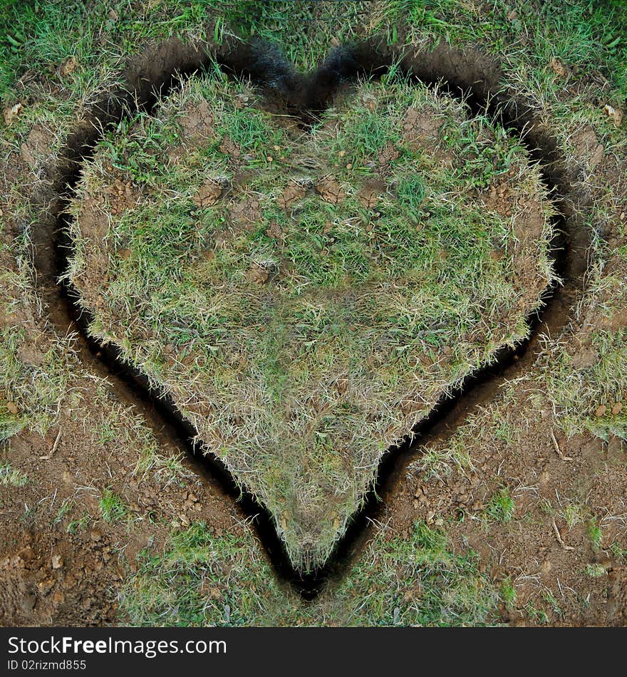 A heart shape dug into the ground as a trench with dirt and grass.