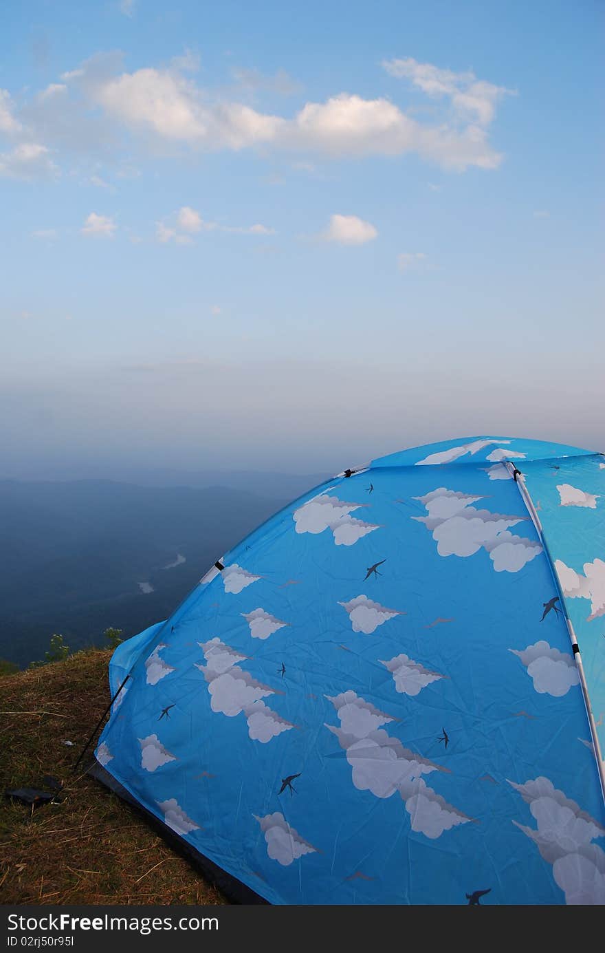 Camping on the top of mountain with blue tent