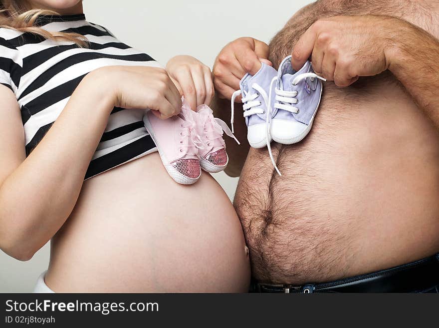 An image of man and woman with little shoes. An image of man and woman with little shoes