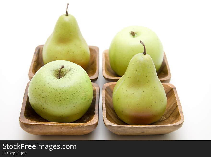 Apple and pear in the wood bowl