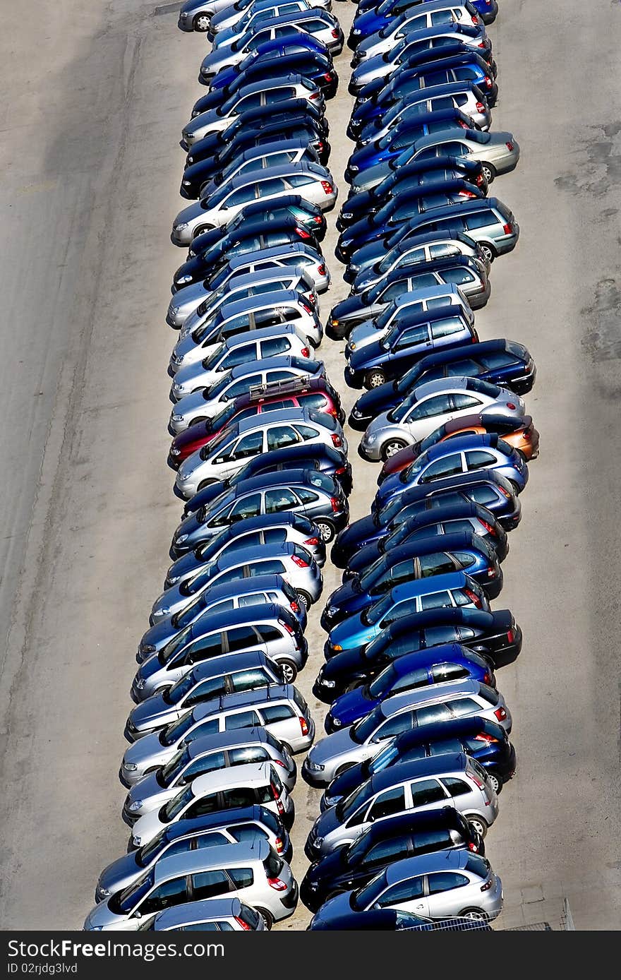 Vertical image of line of cars in a parking-lot seen from elevated point of view. Vertical image of line of cars in a parking-lot seen from elevated point of view