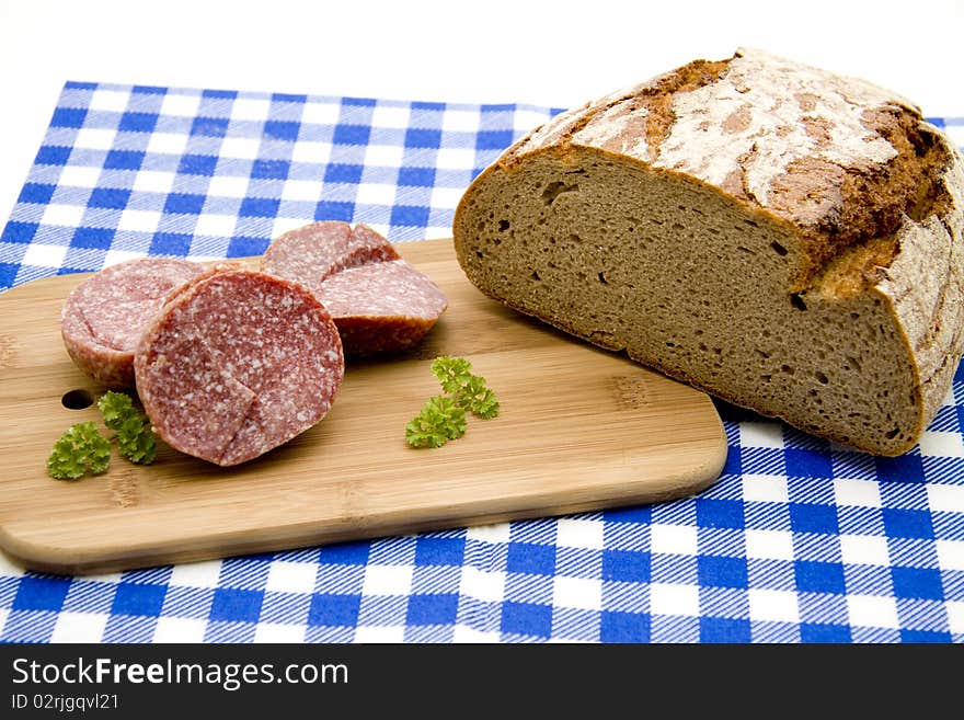 Sausage and bread on table cloth. Sausage and bread on table cloth