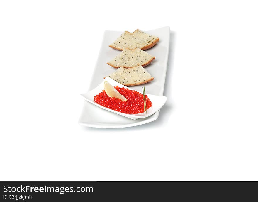 Red caviar  with sliced bread and lemon on plate isolated on white background