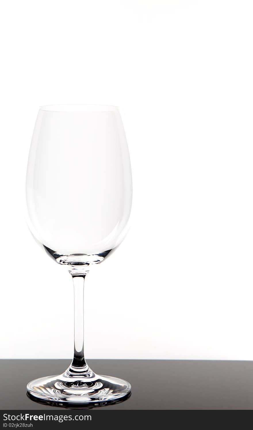 Empty white wine glass with white background