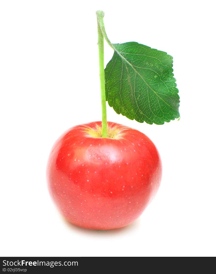 Ripe red apple with green leaf. Isolated on white background.