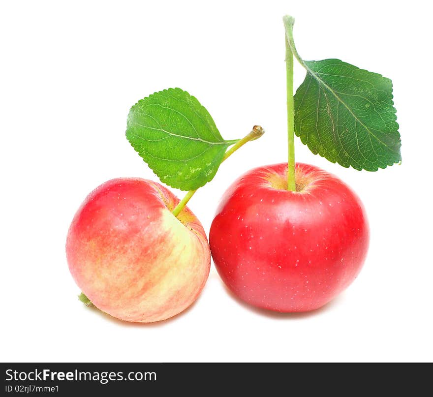 Ripe red apple with green leaf. Isolated on white background.