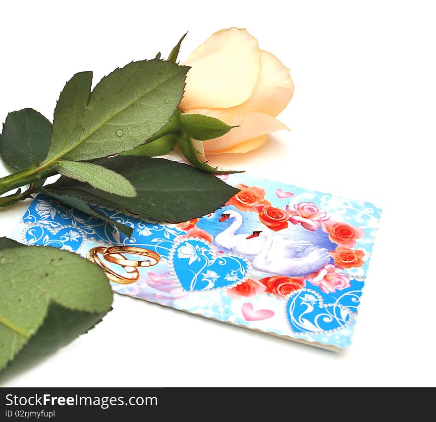 Roses and wedding card on a white background