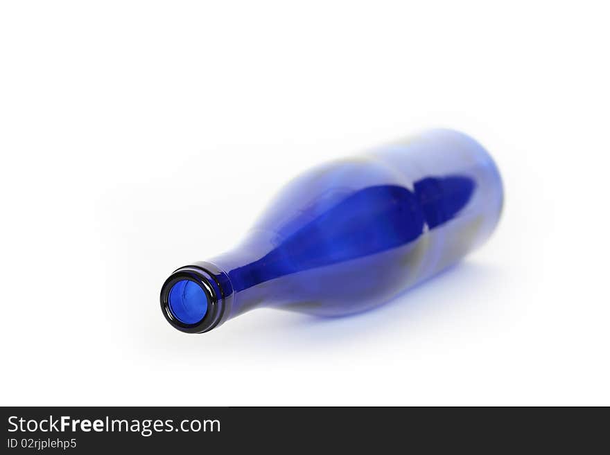 Blue glass empty bottle lying on white background. Blue glass empty bottle lying on white background