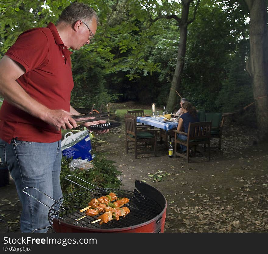 Bbq in the garden with man on foreground