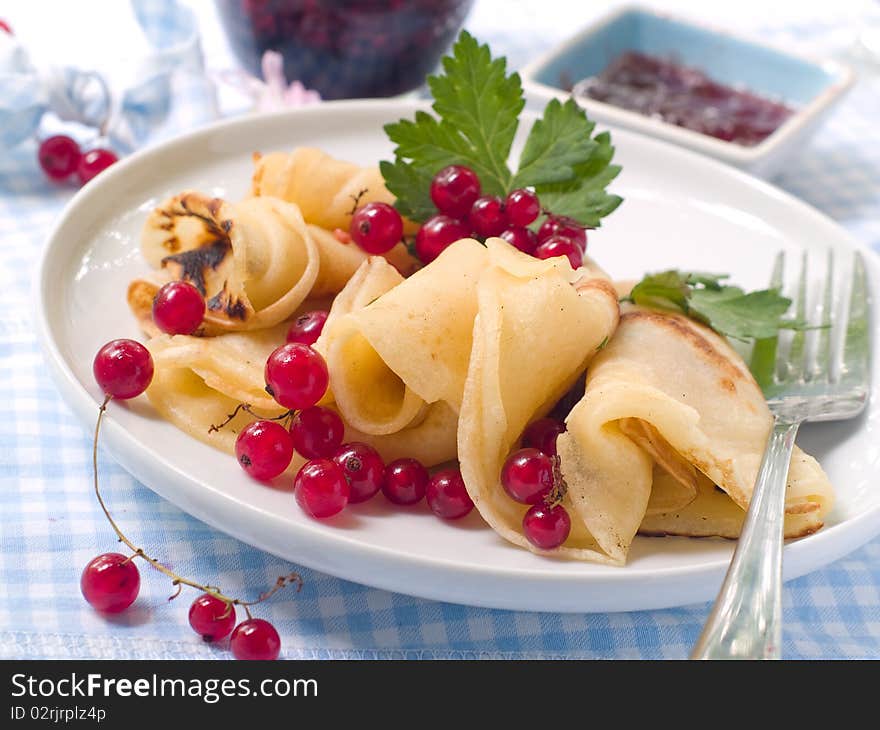 Pancakes with red currant jam for breakfast. Pancakes with red currant jam for breakfast