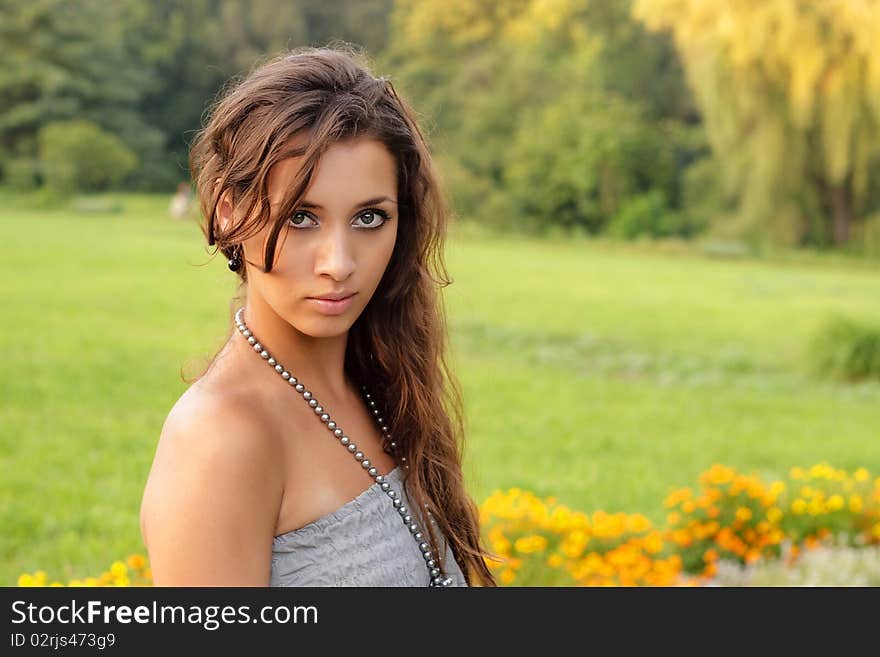 Beautiful young girl standing in the park