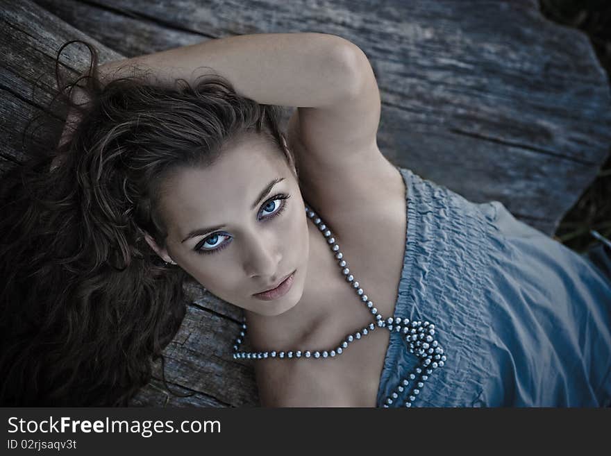 Beautiful young girl lying in the park