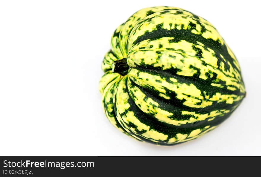 Yellow and green coloured harlequin pumpkin, isolated on white