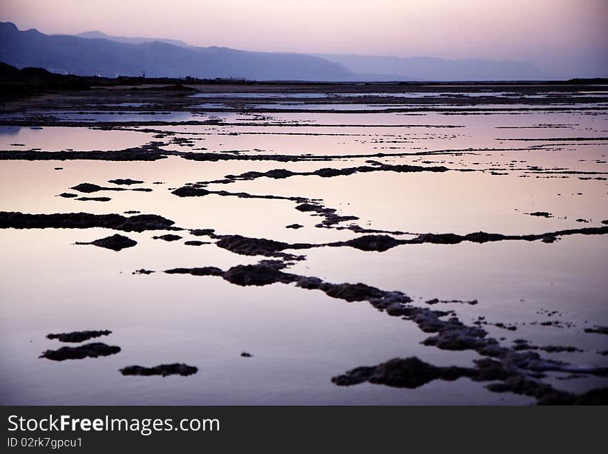 The water of the dead sea with the Jordan mountains at sunset. The water of the dead sea with the Jordan mountains at sunset