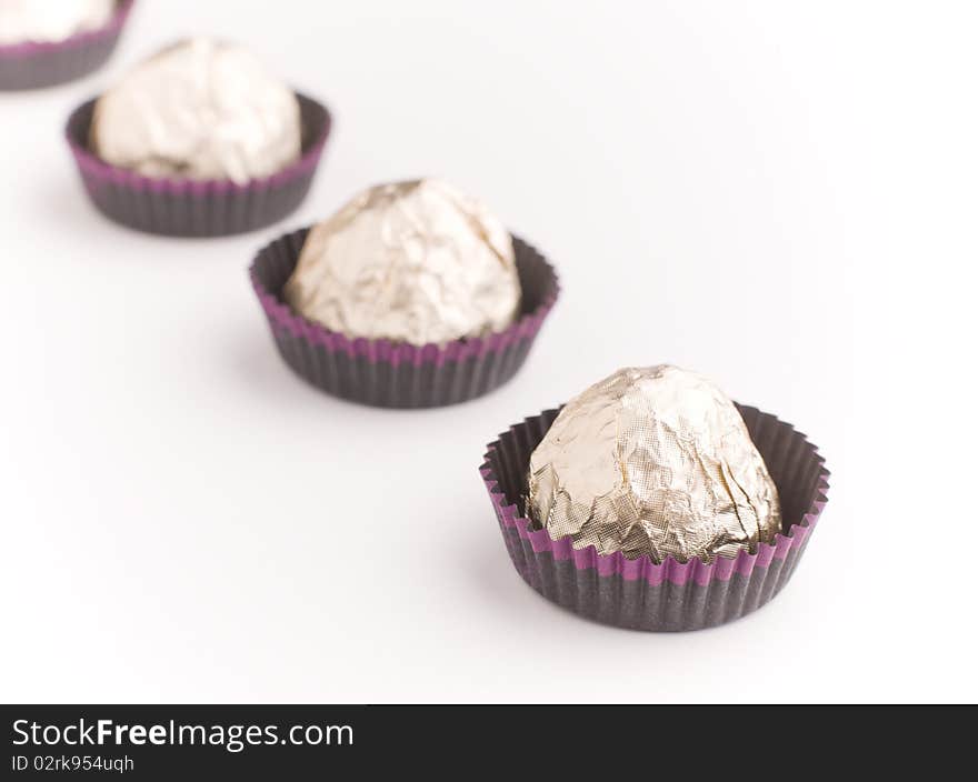 Choco  Candies In Golden Foil On Table